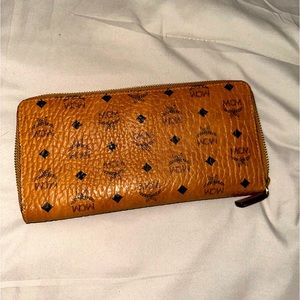 MCM signature monogram wallet with a secure zip-around closure.